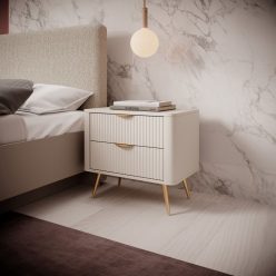 Beżowa zaokrąglona szafka nocna na złotych nogach