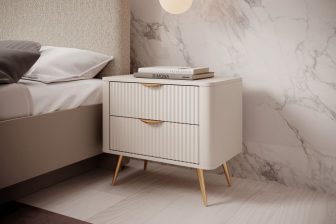 Beżowa zaokrąglona szafka nocna na złotych nogach