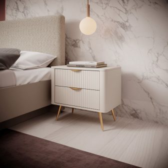 Beżowa zaokrąglona szafka nocna na złotych nogach